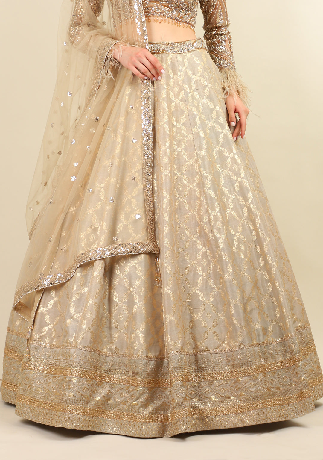 GOLD EMBROIDERED TOP WITH LEHENGA. IT'S PAIRED WITH SCARF.