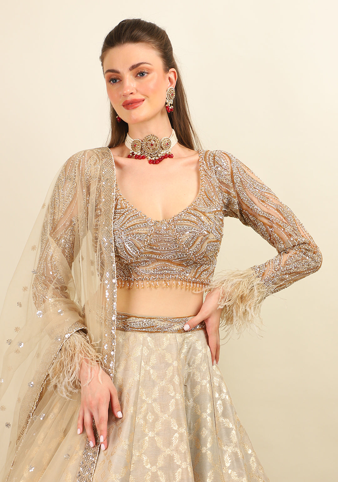 GOLD EMBROIDERED TOP WITH LEHENGA. IT'S PAIRED WITH SCARF.
