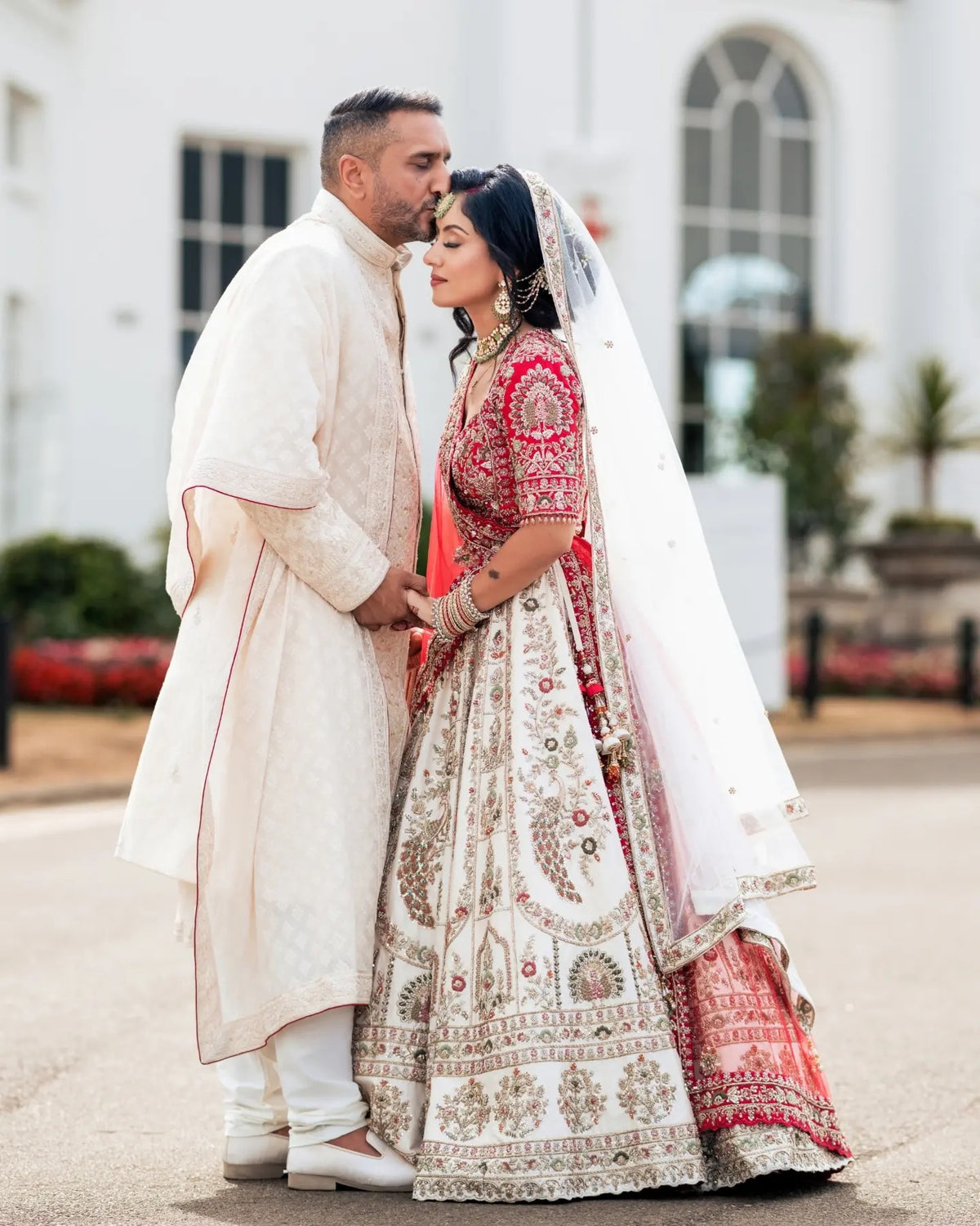 Asha & Pritesh in Ivory & Red Wedding Attire