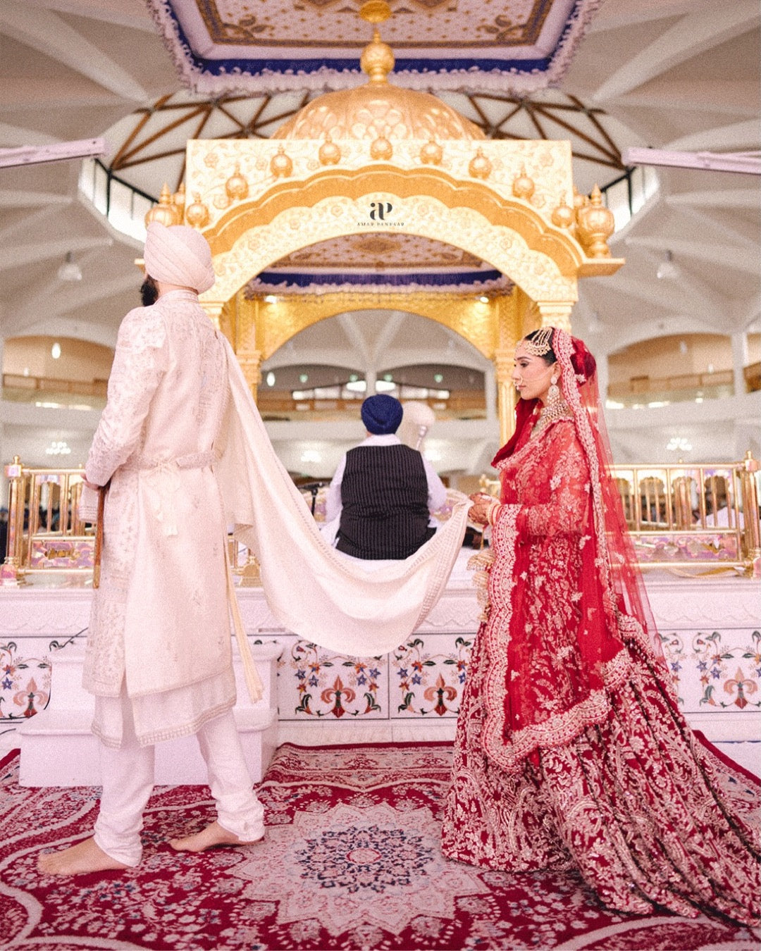 Bride Aman in Maroon Gold Embroidered Lehenga