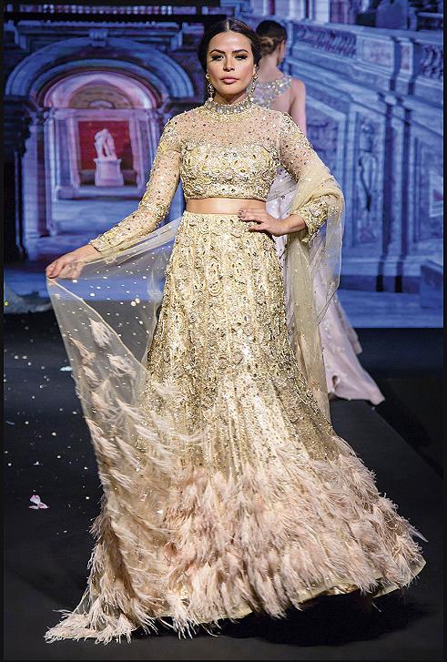 Golden bridal lehenga with feathers
