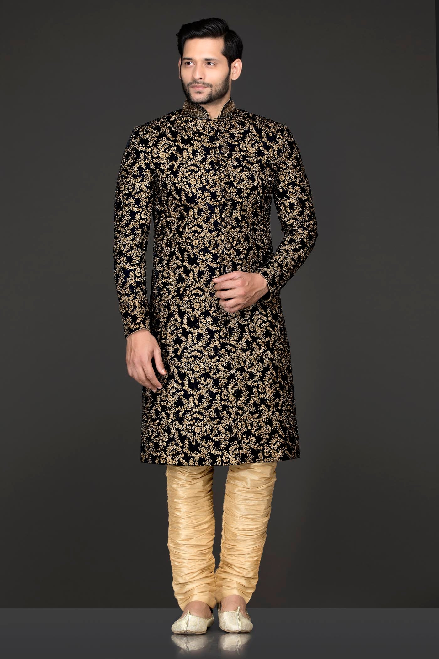 Navy Blue Velvet Sherwani Covered With Gold Zari Embroidery Paired With Gold Chudidar