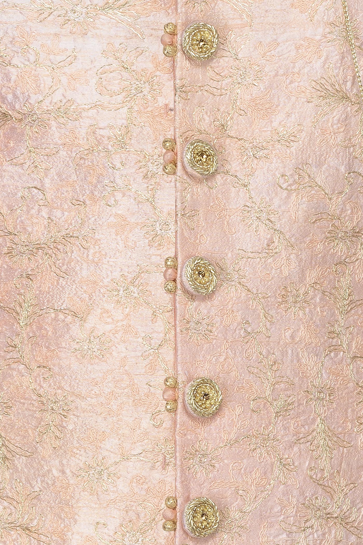 Peach Silk Sherwani With Embroidery On The Collar And Shoulder Brooch With Hanging Tassels Paired With White Trousers