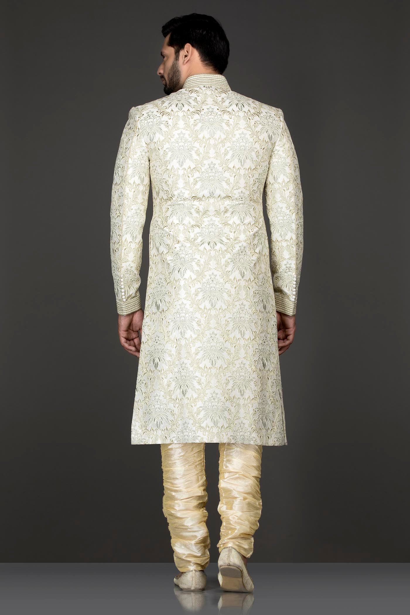 Ivory Colour Silk Sherwani With Silver Zari And Dori Embroidery Paired With Gold Bottoms
