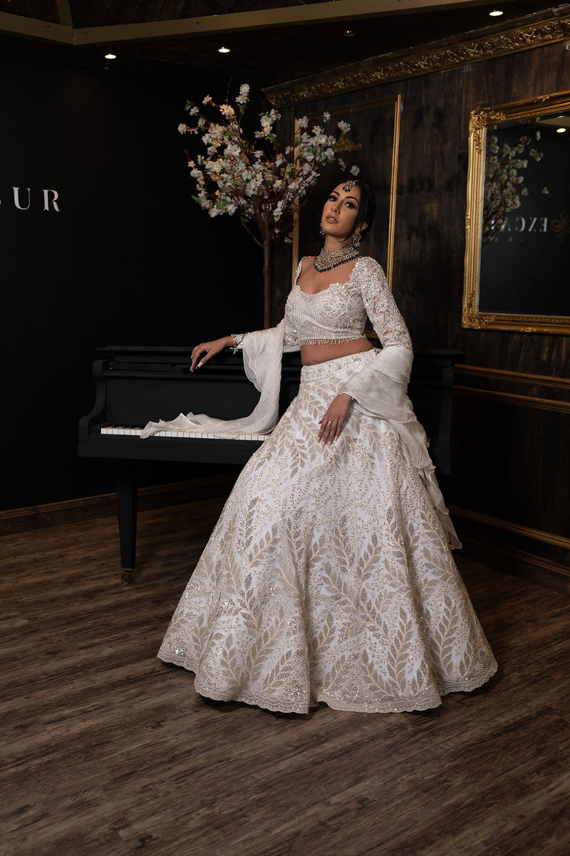 Ivory Lehenga is embroidered with embroidered Top