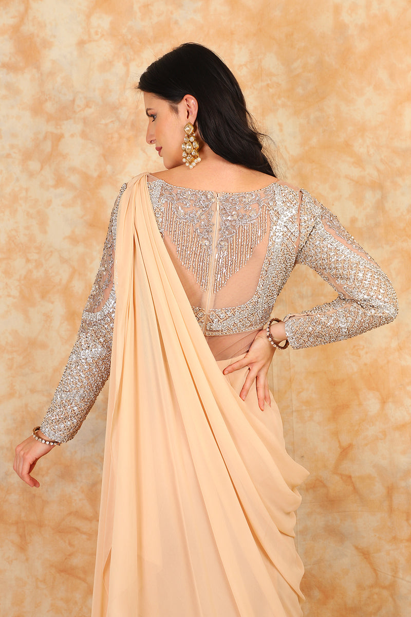 Featuring embroidered blouse with Beige Drape Saree.