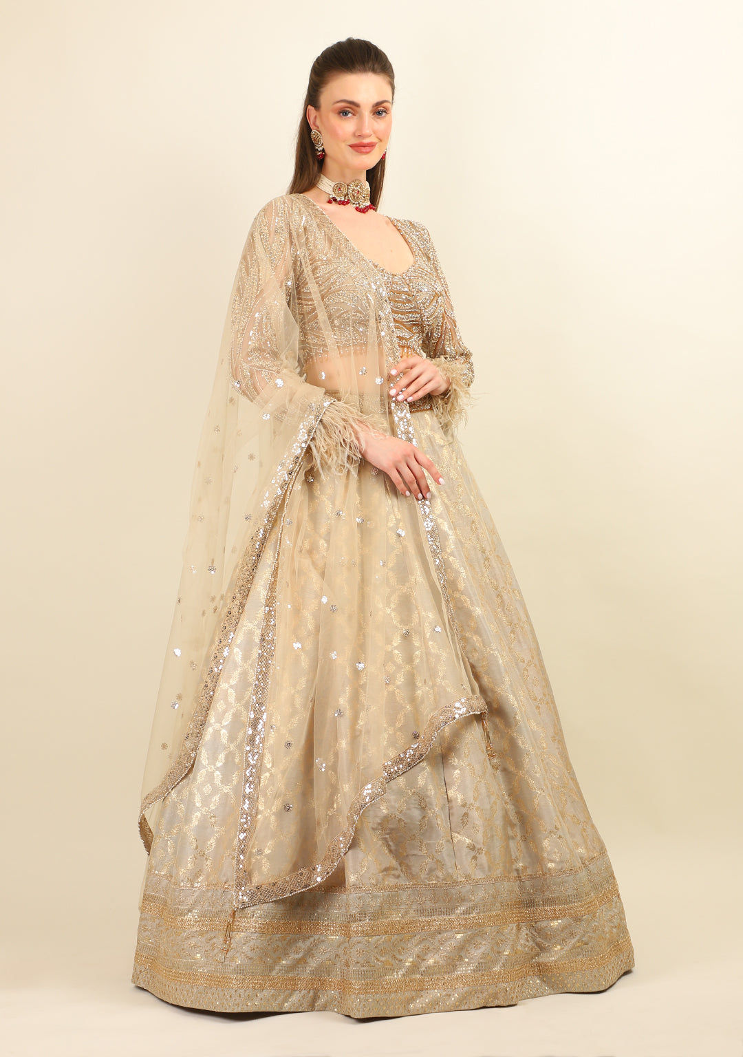 GOLD EMBROIDERED TOP WITH LEHENGA. IT'S PAIRED WITH SCARF.