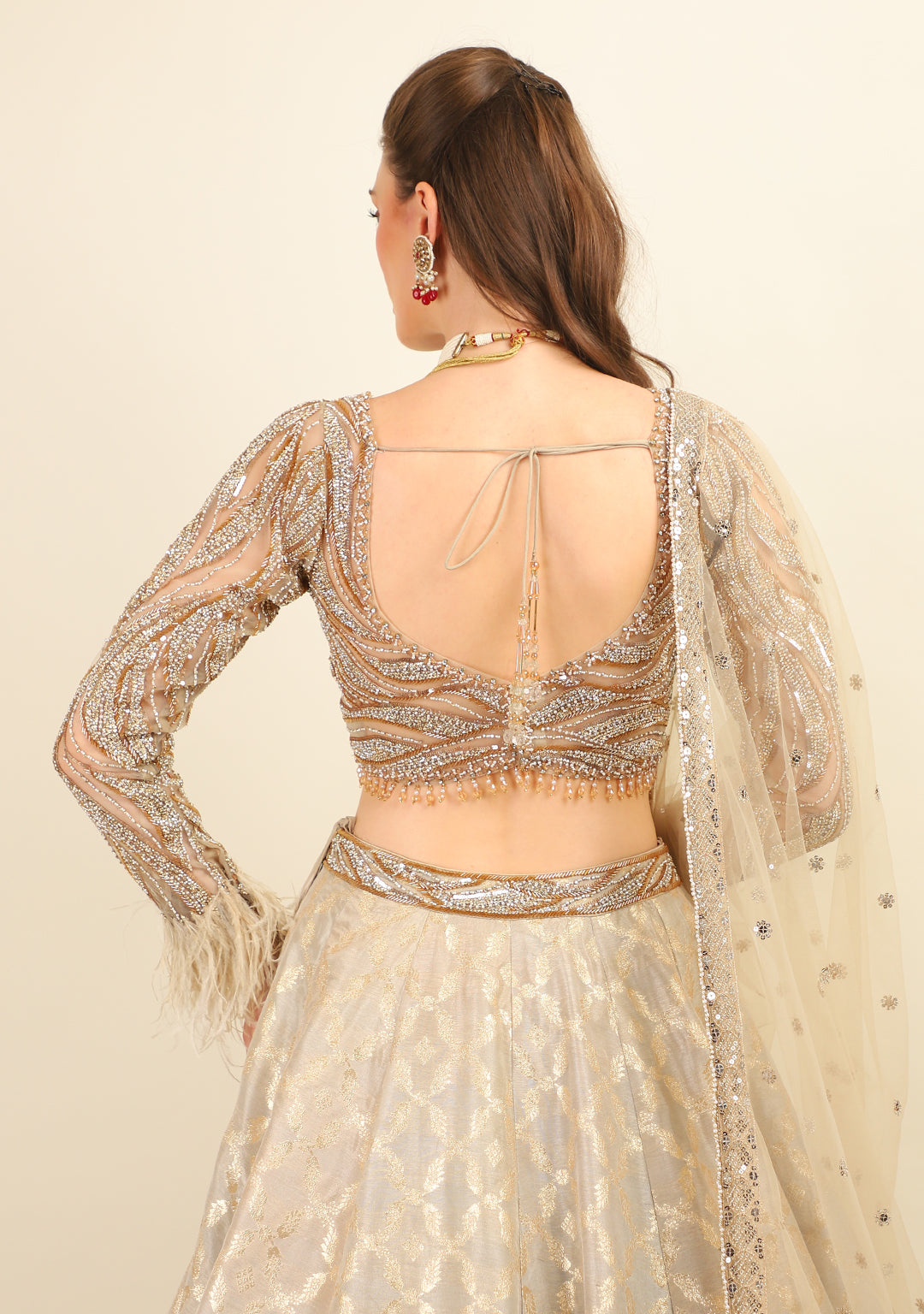 GOLD EMBROIDERED TOP WITH LEHENGA. IT'S PAIRED WITH SCARF.