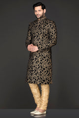 Navy Blue Velvet Sherwani Covered With Gold Zari Embroidery Paired With Gold Chudidar