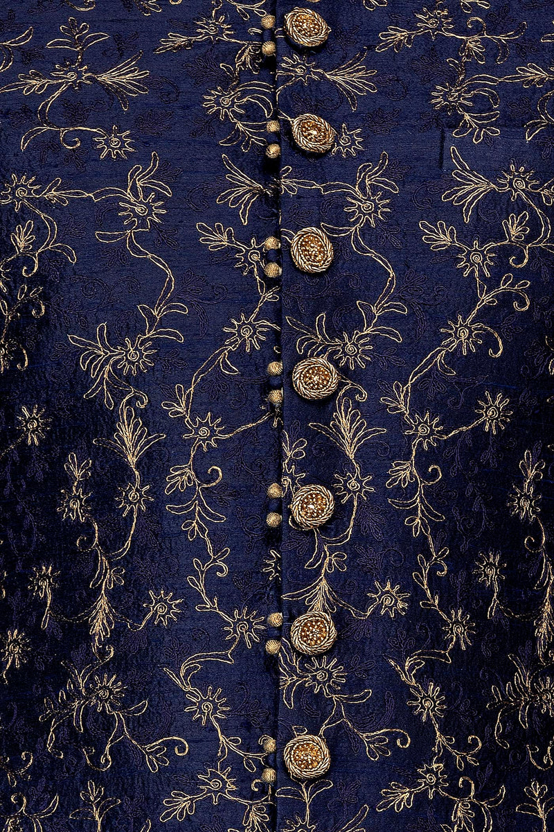 Navy Blue Silk Sherwani With Embroidery On The Collar And Shoulder Brooch With Hanging Tassels Paired With Gold Trousers