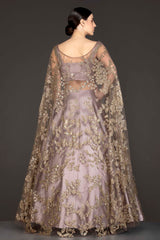 Mauve Colour Silk Skirt With Heavily Embriodered Net Top And Attached Net Cape